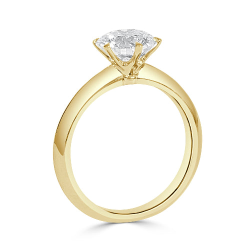 Gold ring with a diamond on a white background