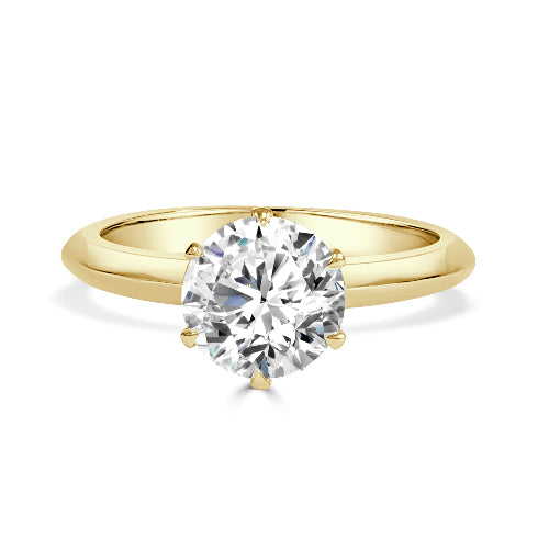 Gold ring with a large diamond on a white background